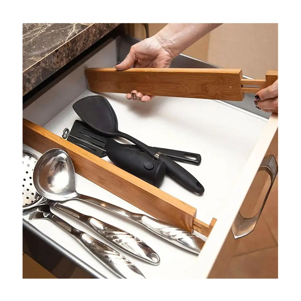 séparateurs de tiroirs en utilisation réelle dans un tiroir compartimentant les espaces pour les ustensiles rangés dans le tiroir